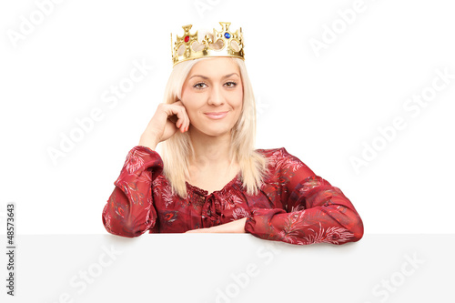Photo: Beautiful queen with a diamond crown posing behind panel Beautiful queen with a diamond crown posing behind panel