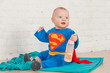 A little baby in Superman suit