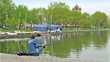 Fisherman on pond in city park