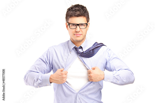 Photo: Young handsome man tearing off his shirt Young handsome man tearing off his shirt