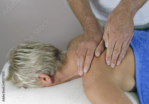 Photo: Male masseur working on shoulder Male masseur working on shoulder