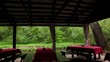 tables in bower ashore of small pond at among trees