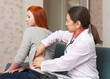 Photo: Mature doctor palpates behind of patient Mature doctor palpates behind of patient