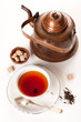 Cup of tea with brown sugar and a vintage teapot