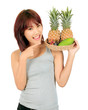 Isolated young asian woman with variety of oriental fruits.