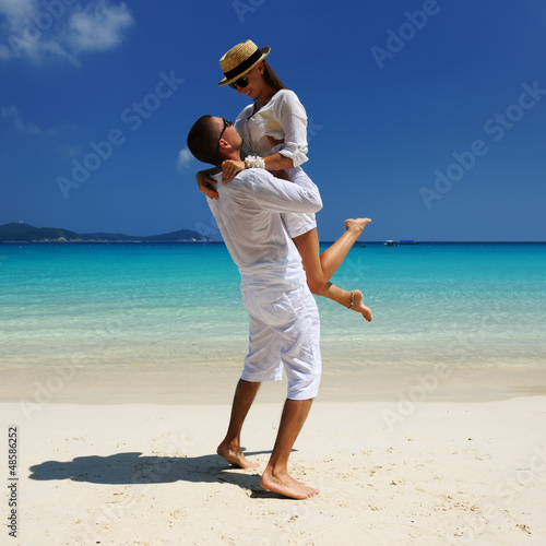 Photo: Couple in white on a beach Couple in white on a beach