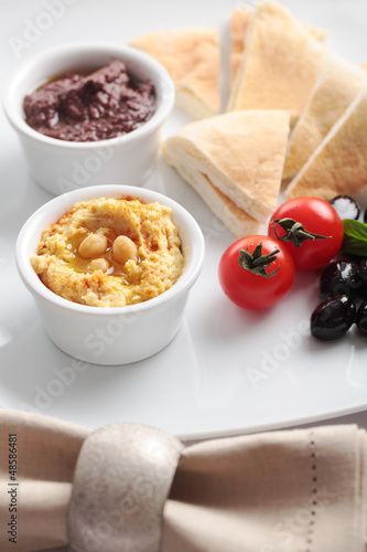 Photo: Meze with tomato, olives, and pita bread Meze with tomato, olives, and pita bread