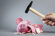 Robbing piggy bank with hammer