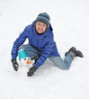 Smiling woman sculpts snowman with blue bucket