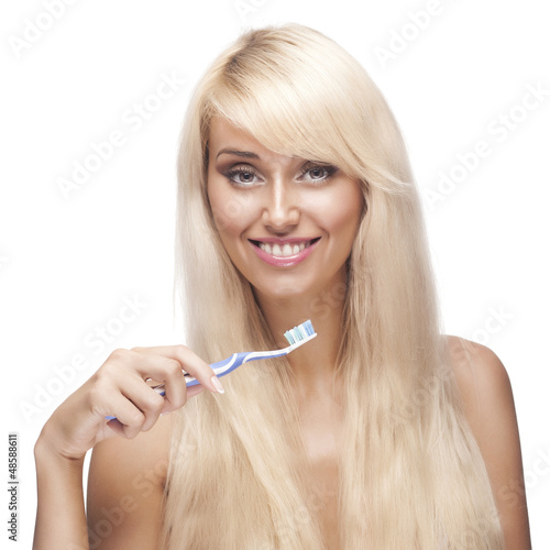 Photo: pretty blonde woman brushing teeth pretty blonde woman brushing teeth