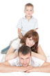Foto: Smiling parents with little son lying on white background Smiling parents with little son lying on white background