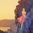 Glamorous beauty on rocky shore