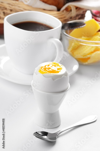 Photo: Breakfast of boiled egg croissant jam butter and coffee Breakfast of boiled egg croissant jam butter and coffee
