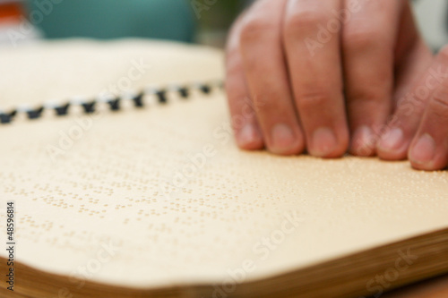 Photo: hand reading in braille hand reading in braille