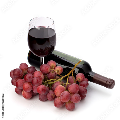 Photo: Full red wine glass goblet, bottle and grapes Full red wine glass goblet, bottle and grapes