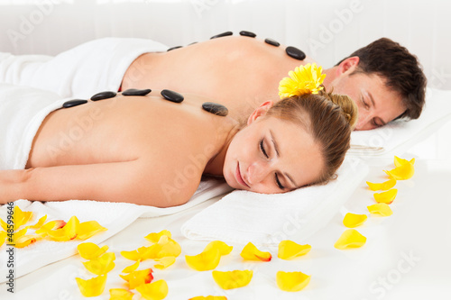 Photo: Couple having a hot stone massage Couple having a hot stone massage