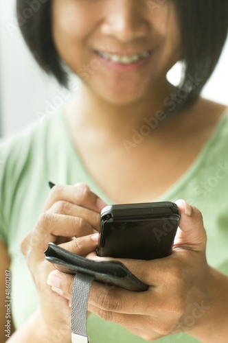 Photo: woman using smartphone woman using smartphone