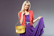 attractive blonde girl with leather handbag and purple dress