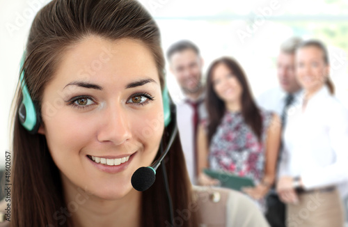 Photo: Female customer support operator with headset and smiling Female customer support operator with headset and smiling