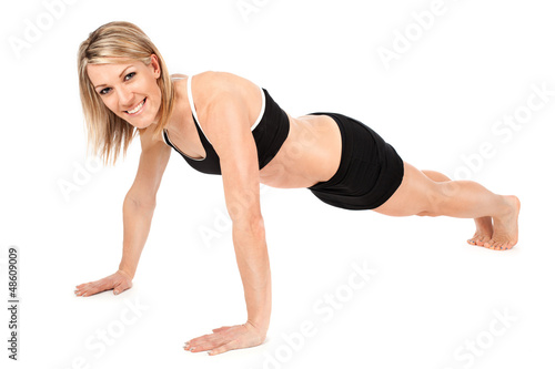 Photo: Beautiful fit young woman doing push ups Beautiful fit young woman doing push ups