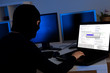 Hacker downloading information off a computer