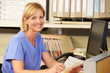 Portrait Of Nurse Working At Nurses Station