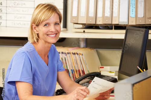 Photo: Portrait Of Nurse Working At Nurses Station Portrait Of Nurse Working At Nurses Station