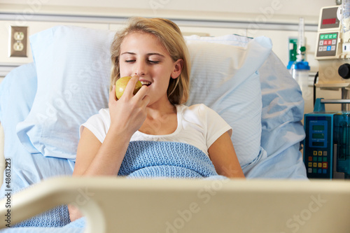 Photo: Teenage Female Patient Eating Apple In Hospital Bed Teenage Female Patient Eating Apple In Hospital Bed