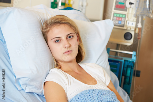 Photo: Depressed Teenage Female Patient Lying In Hospital Bed Depressed Teenage Female Patient Lying In Hospital Bed