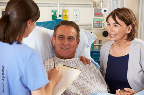 Photo: Nurse Talking To Couple On Ward Nurse Talking To Couple On Ward