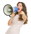 Young woman shouting in megaphone and pointing in camera