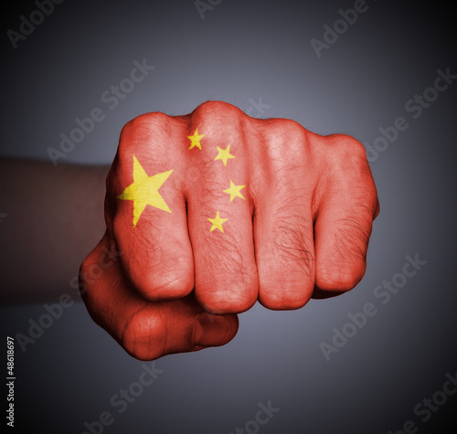 Photo: Front view of punching fist on gray background Front view of punching fist on gray background
