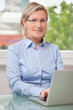 Photo: Smiling senior woman with laptop Smiling senior woman with laptop