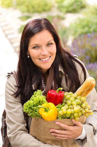 Photo: Smiling woman shopping vegetables groceries paper bag Smiling woman shopping vegetables groceries paper bag