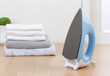 The electric iron with stacks of cloths