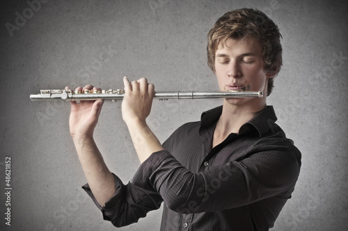 Photo: boy playing flute boy playing flute