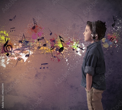 Photo: Young boy listening to music Young boy listening to music