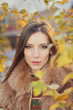 portrait of a beautiful girl in autumn leaves