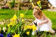 Girl on Easter egg hunt with eggs