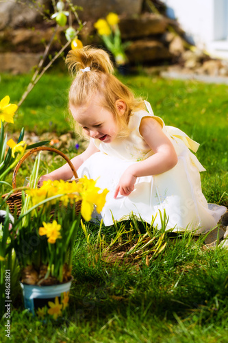 Photo: Girl on Easter egg hunt with eggs Girl on Easter egg hunt with eggs