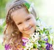 Little girl with branches blossoming apple tree