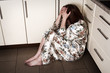Adult woman crying sitting on the floor