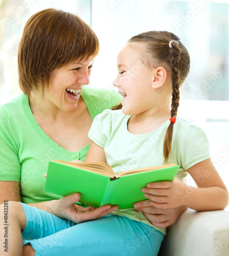 Photo: Mother is reading book with her daughter Mother is reading book with her daughter