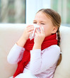 Little girl is blowing her nose
