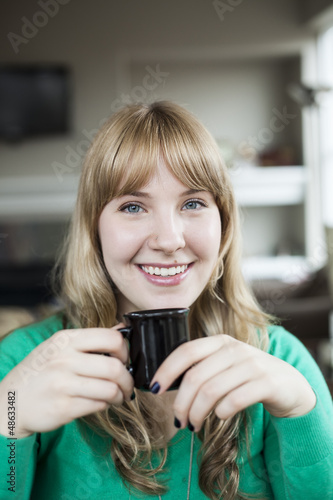 Photo: Young Woman Drinking Coffee Young Woman Drinking Coffee