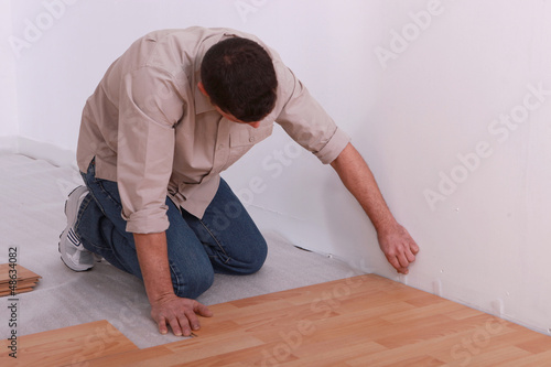 Photo: Man placing wooden floor Man placing wooden floor