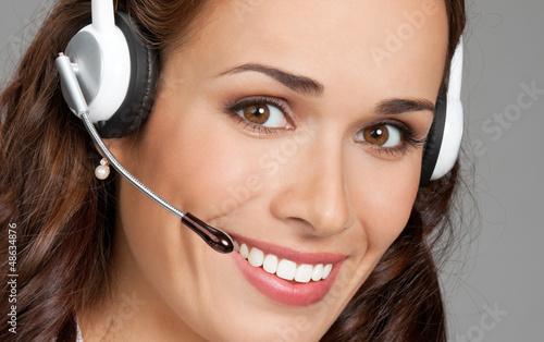 Photo: Support phone operator in headset, on gray Support phone operator in headset, on gray