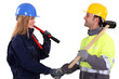 two construction workers shaking hands