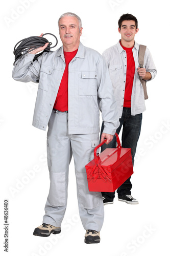 Photo: An electrician and his apprentice. An electrician and his apprentice.