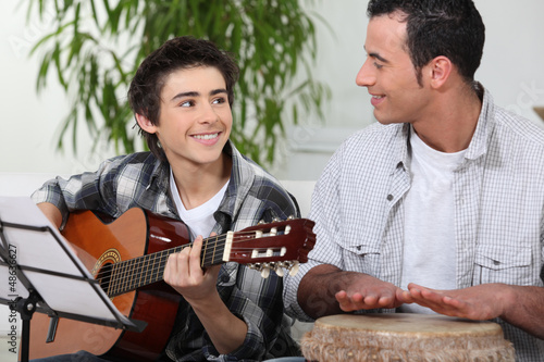 Photo: Father and son playing music Father and son playing music